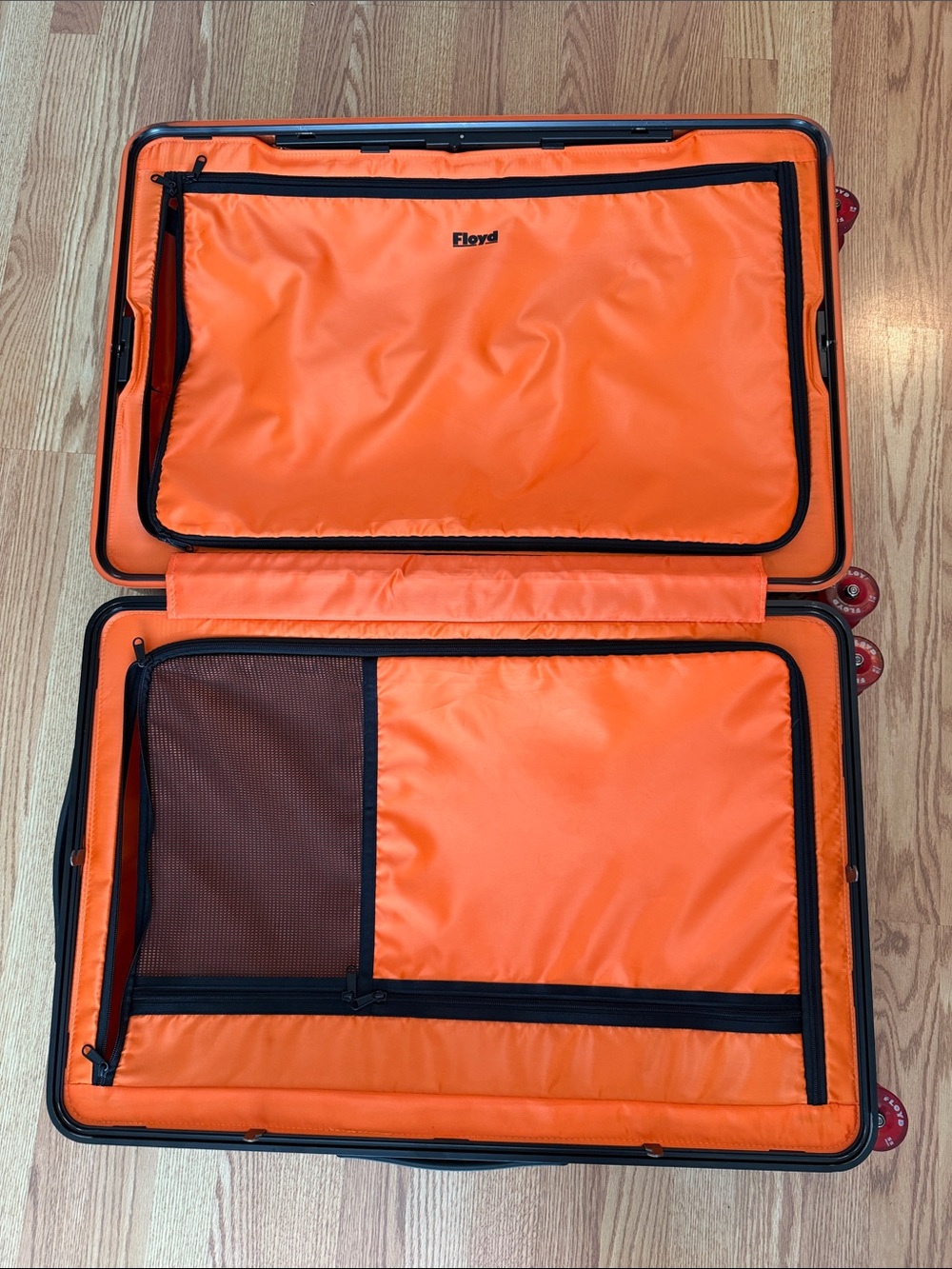 Floyd Brown Hardshell Suitcase with Bright Orange Interior and Red Wheels - Picture 13 of 17